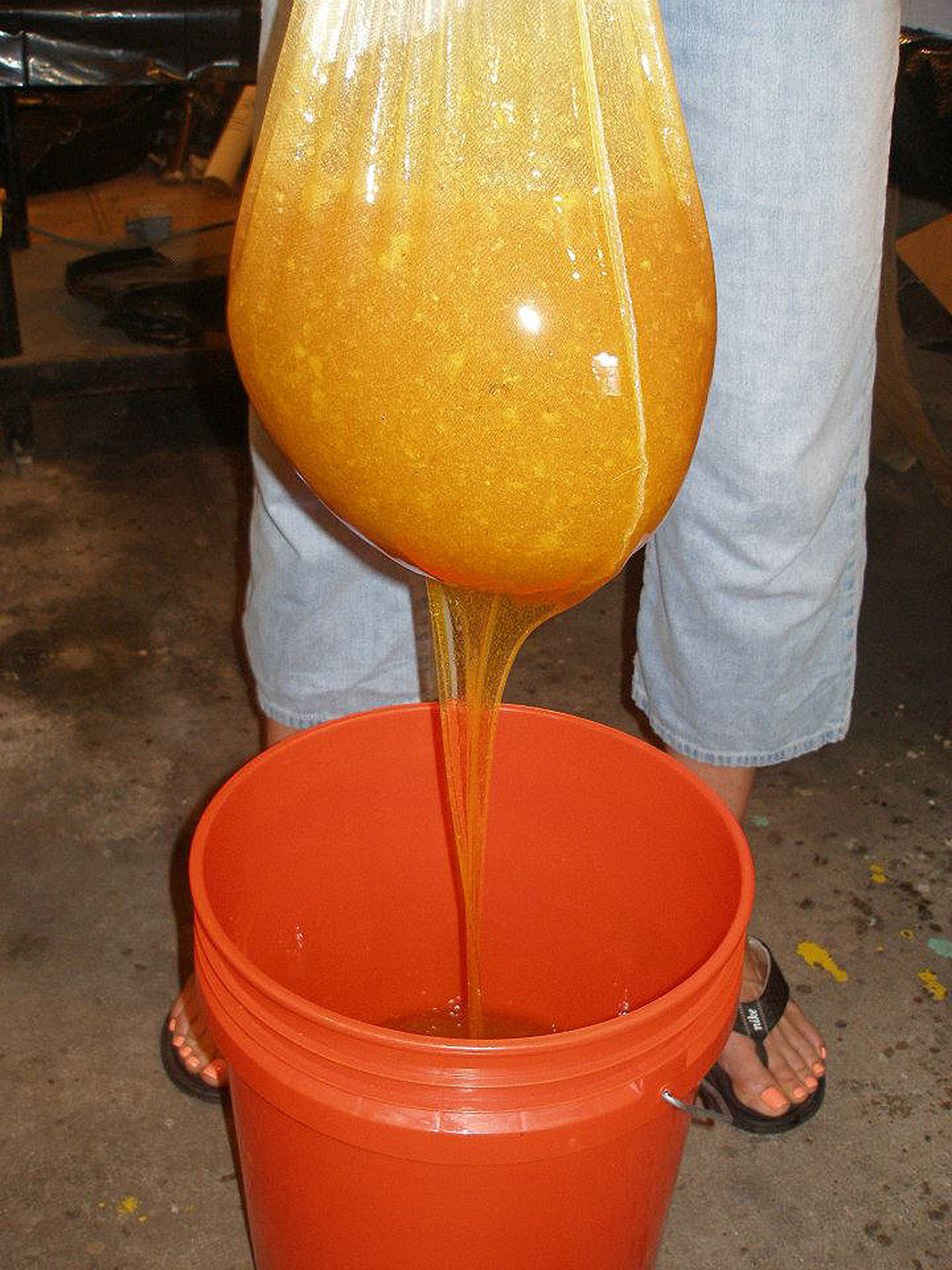 I allow the honey to flow through a cloth strainer to remove any wax particles before transferring to the stainless steel holding tank.